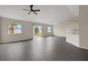 Spacious living room with hard surface floors and large windows overlooking the backyard at 583 Drayton Rd, Winter Haven, FL 33884