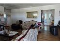 Cozy living room featuring hardwood floors, a decorative mirror, and comfortable seating arrangement at 915 Exmoor Way, Lake Wales, FL 33853