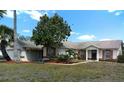 Inviting single-story home with a landscaped front yard, shuttered windows, and a welcoming entrance, blending charm and comfort at 100 Heatherwood Blvd, Lake Wales, FL 33859