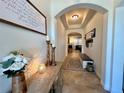 Inviting hallway with archway, decorative accents, and neutral tones offers a warm and welcoming entrance at 1055 Lena Run Ct, Winter Haven, FL 33880
