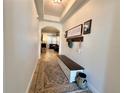 Hallway features archway, decorative rug, and a bench with a storage for an inviting and organized space at 1055 Lena Run Ct, Winter Haven, FL 33880