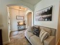 Comfortable living room with plush sofa, decorative pillows, and tranquil lake artwork at 1055 Lena Run Ct, Winter Haven, FL 33880