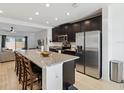 Spacious kitchen with stainless steel appliances, a large granite island, and barstool seating at 141 Claire Ln, Davenport, FL 33837