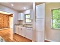 Well-lit kitchen featuring modern appliances, granite countertops, and ample cabinet space at 1475 S Lake Howard Dr, Winter Haven, FL 33880