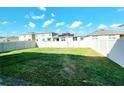 Spacious backyard featuring a well-maintained lawn and a privacy fence at 2005 Carnostie Rd, Winter Haven, FL 33884