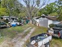 Messy backyard with multiple vehicles and debris at 215 10Th Wahneta W St, Winter Haven, FL 33880