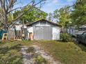 Garage with white and gray paint, surrounded by debris at 215 10Th Wahneta W St, Winter Haven, FL 33880