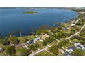 Aerial view of waterfront property showcasing the home's location on the water and surrounding community at 2350 Crump Rd, Winter Haven, FL 33881