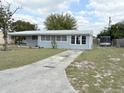 Quaint single-story home featuring a long driveway and mature landscaping at 253 Walter Ave, Frostproof, FL 33843