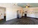 Open-concept kitchen and dining area with modern stainless steel appliances and stylish dark flooring at 3027 Maplewood Ave, Lakeland, FL 33803