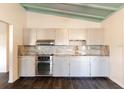 Updated kitchen featuring sleek cabinetry, stainless steel appliances, and elegant granite countertops at 3027 Maplewood Ave, Lakeland, FL 33803