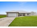 Well-maintained home featuring an attached two car garage, covered entry way, and large front yard at 3608 Garrard Rd, Fort Meade, FL 33841