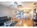 A spacious living room showcases an open-concept layout with wood floors, a kitchen view, and modern furniture at 398 Winter Ridge Blvd # 398, Winter Haven, FL 33881