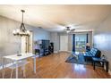 Bright living room featuring wood flooring, a modern chandelier, and lots of natural light at 398 Winter Ridge Blvd # 398, Winter Haven, FL 33881