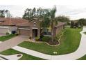 Attractive single-story home showcasing manicured landscaping and a brick driveway at 4004 Prima Lago Cir, Lakeland, FL 33810
