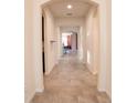 Inviting hallway featuring tile flooring and arched doorways, creating a seamless flow throughout the home at 4004 Prima Lago Cir, Lakeland, FL 33810