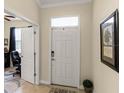 Bright entryway featuring a white front door and neutral decor at 4009 Bedford Ave, Winter Haven, FL 33884