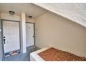 Condo entrance featuring two white doors, neutral wall textures, and a welcoming outdoor rug at 404 Laurel Cove Way # 404, Winter Haven, FL 33884