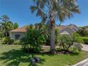 Well-maintained single-story home with an attached garage, lush landscaping, and a verdant lawn at 4168 Aberdeen Ln, Lake Wales, FL 33859