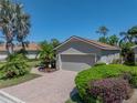 Charming one-story home with lush landscaping, green grass, and a two-car garage at 4168 Aberdeen Ln, Lake Wales, FL 33859