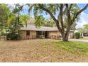 Lovely single-story brick home with a screened entryway, surrounded by mature landscaping at 4615 Reynosa Sw Dr, Winter Haven, FL 33880