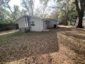 Back exterior view of the home featuring HVAC and back entry at 626 N Nashua Ave, Fort Meade, FL 33841