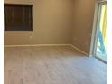Bright and airy living room with tile flooring and sliding glass doors to the outside at 708 E Broadway St, Fort Meade, FL 33841