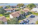 Aerial view of the building with palm trees, parking, and a glimpse of the lake in the background at 900 Avenue Z Se # A3, Winter Haven, FL 33880