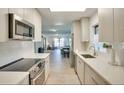 Modern kitchen featuring sleek white cabinets, stainless steel appliances, and an open layout at 919 Avenue S Se, Winter Haven, FL 33880