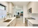 Updated kitchen featuring stylish white cabinets, stainless steel appliances, and an open design at 919 Avenue S Se, Winter Haven, FL 33880