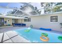 Sparkling screened-in pool area, perfect for relaxation and recreation, and featuring ample seating at 919 Avenue S Se, Winter Haven, FL 33880