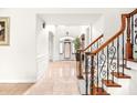 Bright foyer with glossy tile floors and decorative stairway at 926 S Lakeshore Blvd, Lake Wales, FL 33853