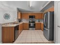 Spacious kitchen featuring stainless steel appliances, light countertops, and wood cabinets at 991 Old Scenic Hwy, Lake Wales, FL 33853