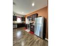 Well-equipped kitchen with stainless steel appliances, dark cabinets, and a convenient layout at 1056 Naes Ln, Lake Wales, FL 33853