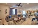 Spacious living room with a gray sectional sofa and views of the dining area and kitchen at 1091 Sugarwood St, Davenport, FL 33837