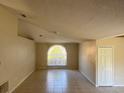 Bright living room with natural light streaming through a large window, complemented by tiled floors and neutral walls at 1106 Partridge Way, Kissimmee, FL 34759