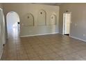 Inviting living room with neutral walls, tiled floors, and arched features, creating a bright and airy space at 1106 Partridge Way, Kissimmee, FL 34759