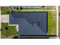 High angle aerial view of the home's roof and back yard, featuring a dark shingle roof at 1108 Zion Dr, Haines City, FL 33844