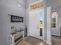 Welcoming foyer with stylish decor, neutral walls, and a view of the outdoors at 1124 Sawgrass Dr, Winter Haven, FL 33884