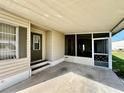 Covered carport featuring direct access to the front door and a convenient adjacent screened area at 114 Jana Cir, Auburndale, FL 33823