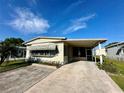 Cozy single-story home featuring a convenient covered carport and a tidy front yard at 114 Jana Cir, Auburndale, FL 33823