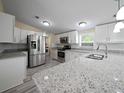 Modern kitchen featuring stainless steel appliances and granite countertops at 1302 Windsong Dr, Lakeland, FL 33811