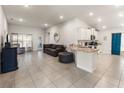 Open concept living room and kitchen, featuring modern finishes and a cozy atmosphere at 135 Krenson Bay Loop, Winter Haven, FL 33881
