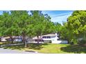An elevated angle showcases the home's location surrounded by green spaces and mature trees at 151 Lake Ring Dr, Winter Haven, FL 33884