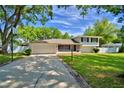 Inviting exterior of a two-story home featuring a two car garage, brick-lined driveway, and manicured lawn at 151 Lake Ring Dr, Winter Haven, FL 33884