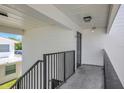 A second story unit exterior with white brick and black painted rails and door at 1550 11Th Ne St # G6, Winter Haven, FL 33881