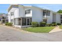 Exterior of building with screened porch, manicured lawn, and walkway at 1550 11Th Ne St # G6, Winter Haven, FL 33881