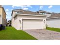 Spacious detached two-car garage with brick driveway and well-manicured lawn at 1744 Cross Prairie Pkwy, Kissimmee, FL 34744