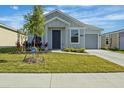 Beautifully landscaped front yard with green grass and an ADT security system sign at 1998 Sarah St, Winter Haven, FL 33884