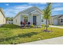 A charming home with landscaped lawn and front yard featuring newly planted trees at 1998 Sarah St, Winter Haven, FL 33884